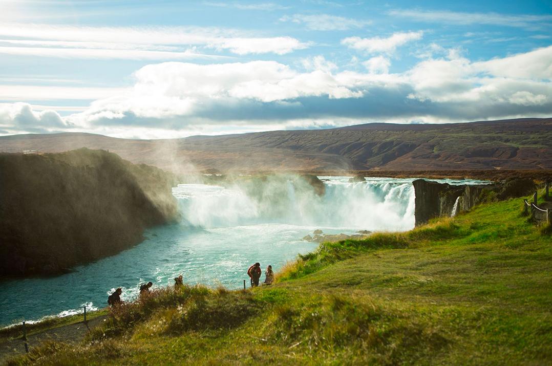 tour group walking along path before the Godafoss waterfall in Iceland